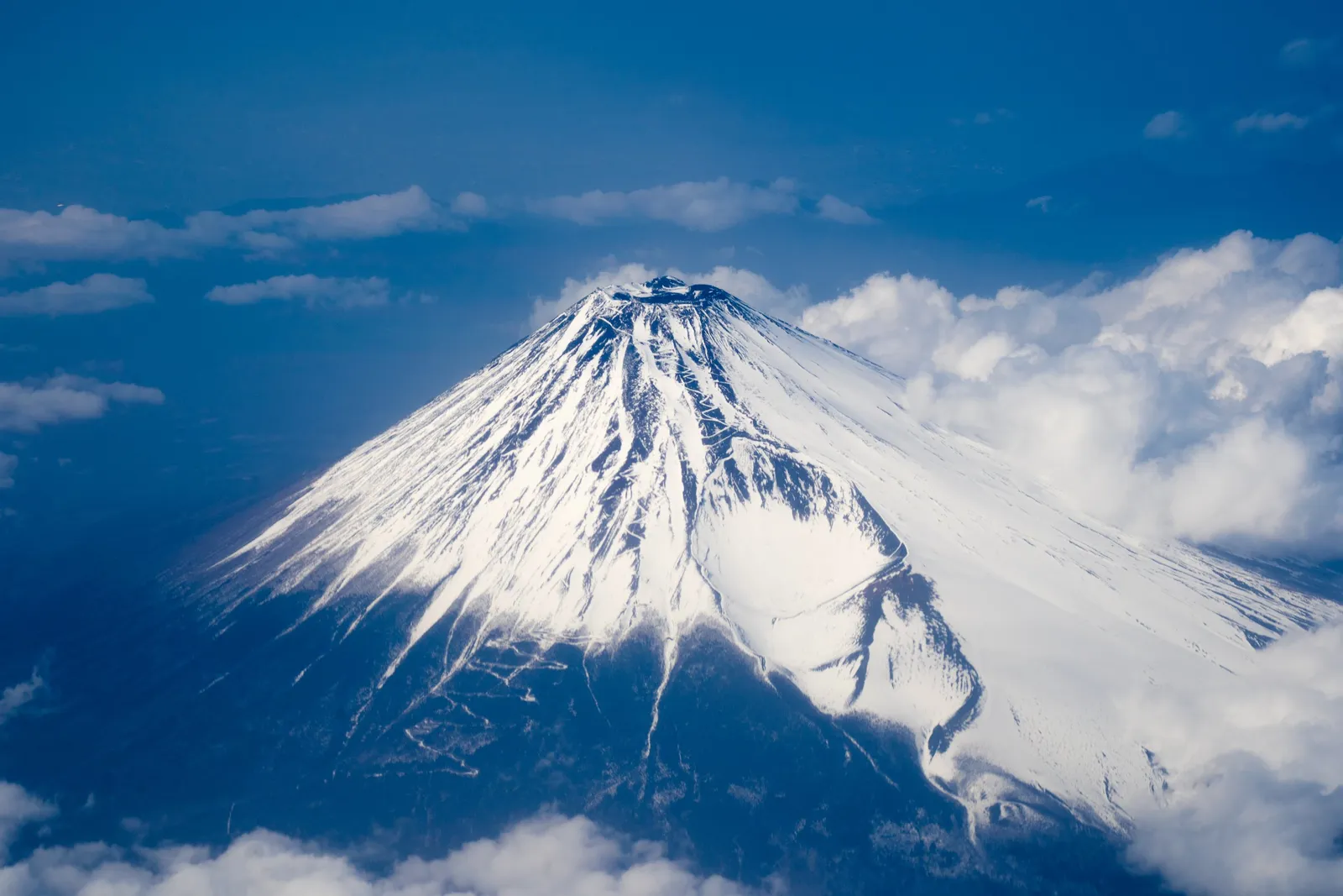 Snow-covered Mount Fuji seen from an airplane window