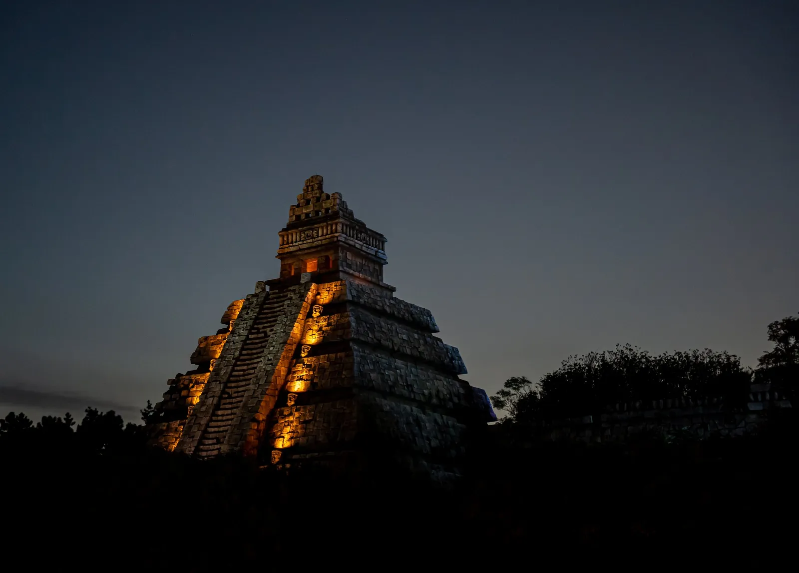 A stone pyramid glowing at dusk