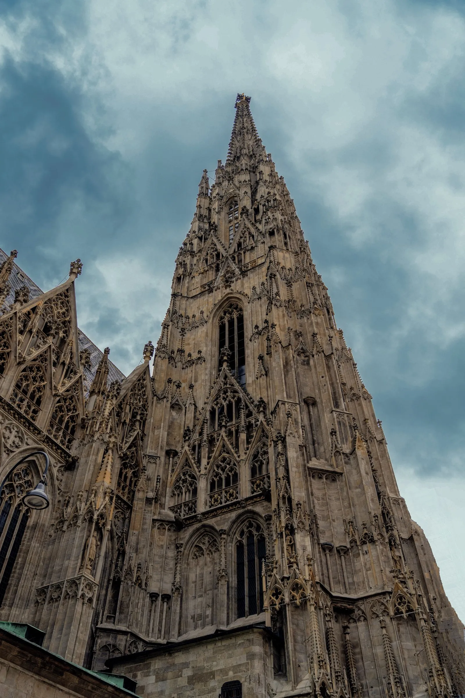 The gothic south tower of St. Stephen's Cathedral against storm clouds