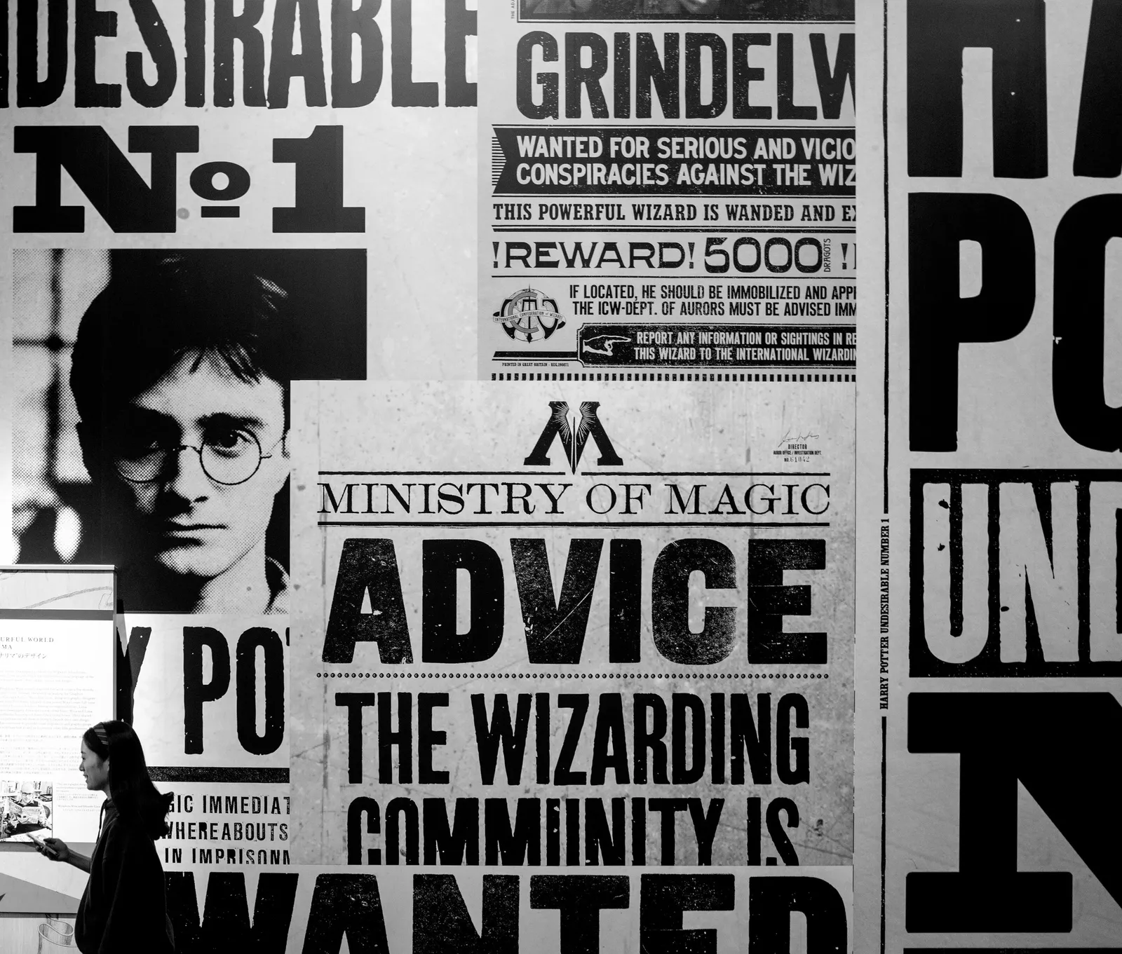 A wall of wizarding-world wanted posters in black and white